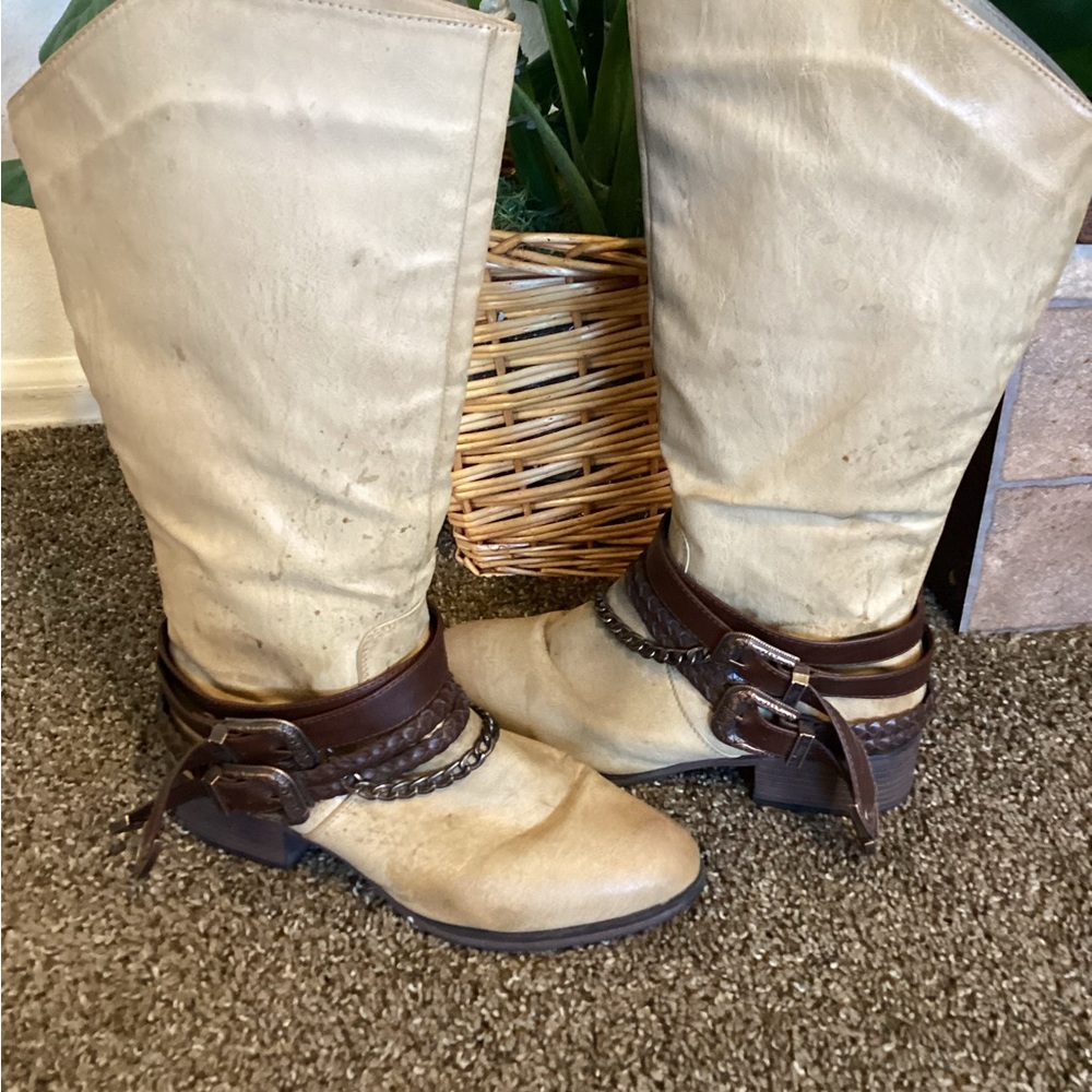 Tan knee boots with brown leather belts and chains. Boots have brown flicks in.